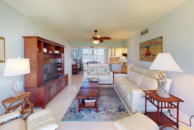 3492 NE Causeway Blvd Unit 104, Jensen Beach, FL 34957 - living room with ceiling fan and a textured ceiling