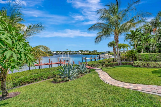 102 Victory Dr, Jupiter, FL 33477 - view of grassy yard with boat lift, a boat dock, and a water view