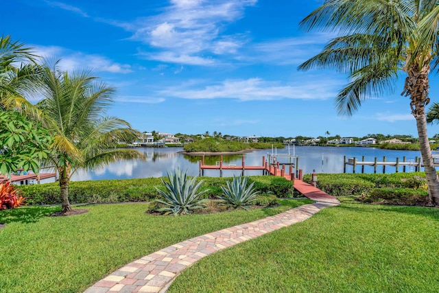 102 Victory Dr, Jupiter, FL 33477 - view of grassy yard featuring boat lift, a boat dock, and a water view