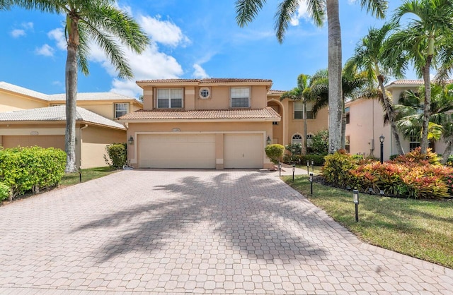 12358 Saint Simon Dr, Boca Raton, FL 33428 - mediterranean / spanish-style home with stucco siding, decorative driveway, a tiled roof, and a garage