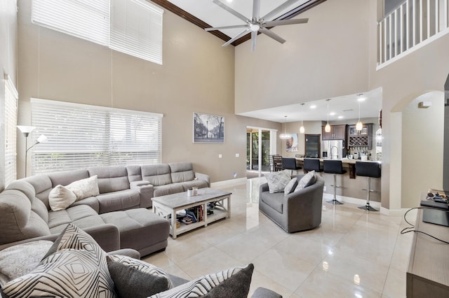 12358 Saint Simon Dr, Boca Raton, FL 33428 - living area featuring a high ceiling, a ceiling fan, arched walkways, and light tile patterned floors