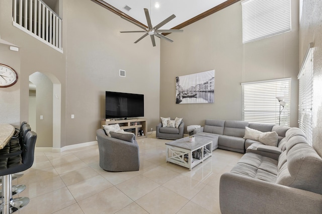 12358 Saint Simon Dr, Boca Raton, FL 33428 - living area featuring a high ceiling, arched walkways, a ceiling fan, light tile patterned floors, and crown molding