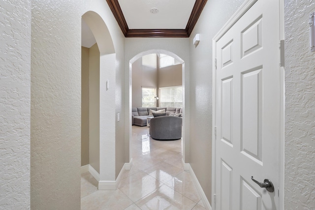 12358 Saint Simon Dr, Boca Raton, FL 33428 - corridor with a textured wall, arched walkways, crown molding, and light tile patterned floors