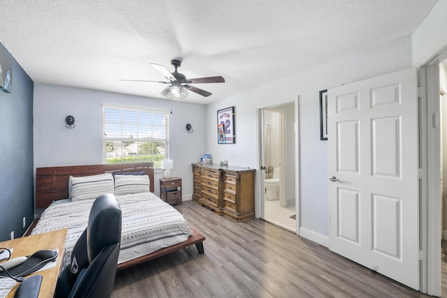 12358 Saint Simon Dr, Boca Raton, FL 33428 - bedroom with wood finished floors, a textured ceiling, ensuite bathroom, and a ceiling fan