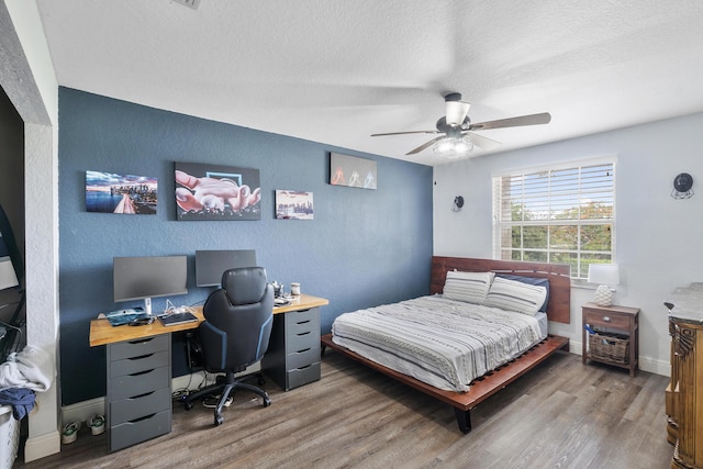 12358 Saint Simon Dr, Boca Raton, FL 33428 - bedroom featuring a textured ceiling, wood finished floors, a desk, a textured wall, and a ceiling fan