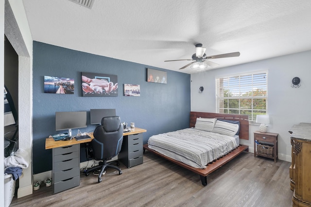 12358 Saint Simon Dr, Boca Raton, FL 33428 - bedroom featuring wood finished floors, a desk, a textured ceiling, and a ceiling fan