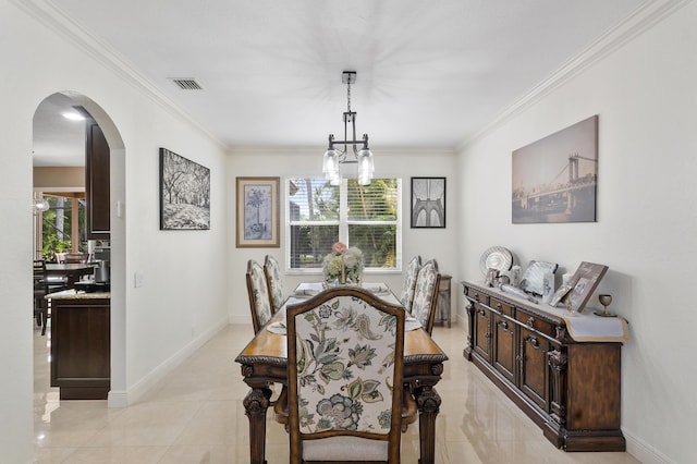12358 Saint Simon Dr, Boca Raton, FL 33428 - dining space with a chandelier, arched walkways, ornamental molding, and light tile patterned floors
