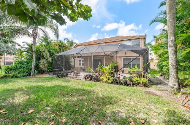 12358 Saint Simon Dr, Boca Raton, FL 33428 - rear view of house with stucco siding, a yard, a patio area, and glass enclosure