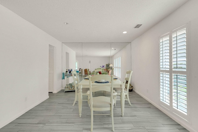 3824 SE Fairway E, Stuart, FL 34997 - dining space with plenty of natural light, a textured ceiling, light wood-style floors, and recessed lighting