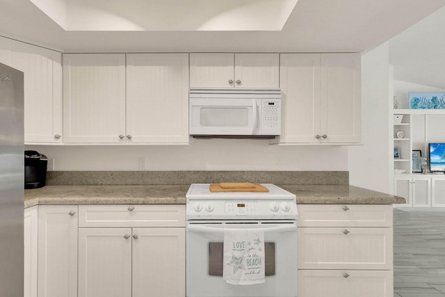 3824 SE Fairway E, Stuart, FL 34997 - kitchen featuring white appliances, white cabinets, and light countertops