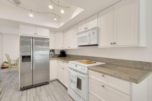 3824 SE Fairway E, Stuart, FL 34997 - kitchen with white appliances, white cabinetry, light countertops, and a tray ceiling
