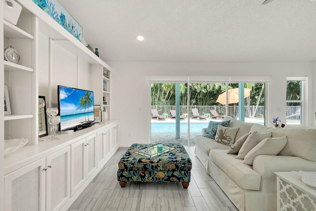 3824 SE Fairway E, Stuart, FL 34997 - living area with a textured ceiling and recessed lighting