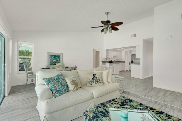 3824 SE Fairway E, Stuart, FL 34997 - living area featuring a ceiling fan, light wood finished floors, and lofted ceiling