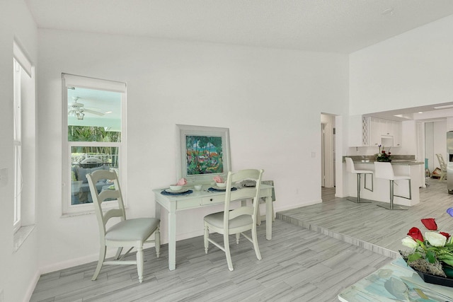 3824 SE Fairway E, Stuart, FL 34997 - dining area featuring light wood-style flooring and baseboards