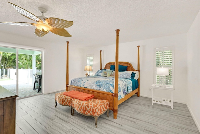 3824 SE Fairway E, Stuart, FL 34997 - bedroom featuring access to exterior, light wood finished floors, a textured ceiling, and ceiling fan