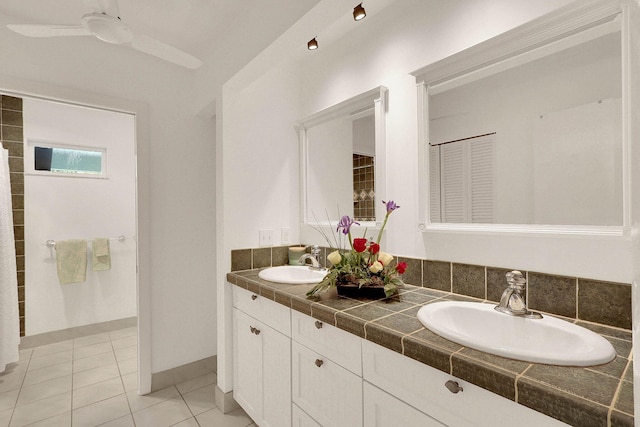 3824 SE Fairway E, Stuart, FL 34997 - full bath featuring double vanity, tile patterned flooring, and a ceiling fan