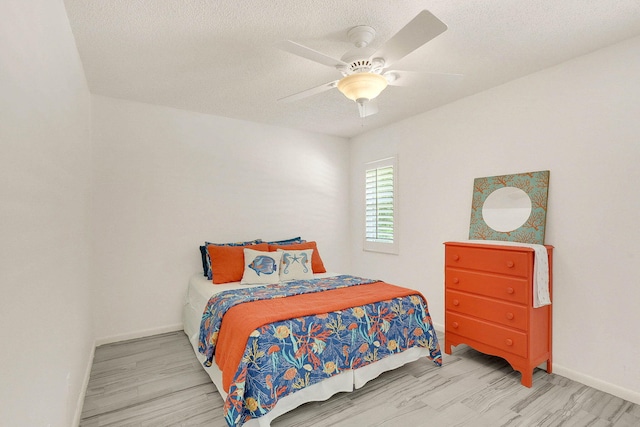 3824 SE Fairway E, Stuart, FL 34997 - bedroom with wood finished floors, a textured ceiling, and ceiling fan