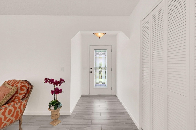 3824 SE Fairway E, Stuart, FL 34997 - doorway to outside featuring baseboards and wood finished floors