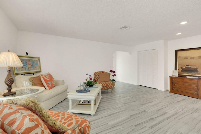 3824 SE Fairway E, Stuart, FL 34997 - living room featuring wood finished floors, recessed lighting, and a textured ceiling