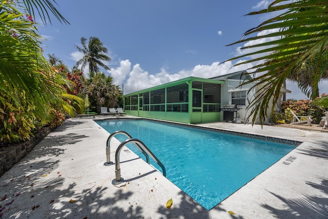 815 Green St, West Palm Beach, FL 33405 - outdoor pool with a sunroom, a patio area, and area for grilling