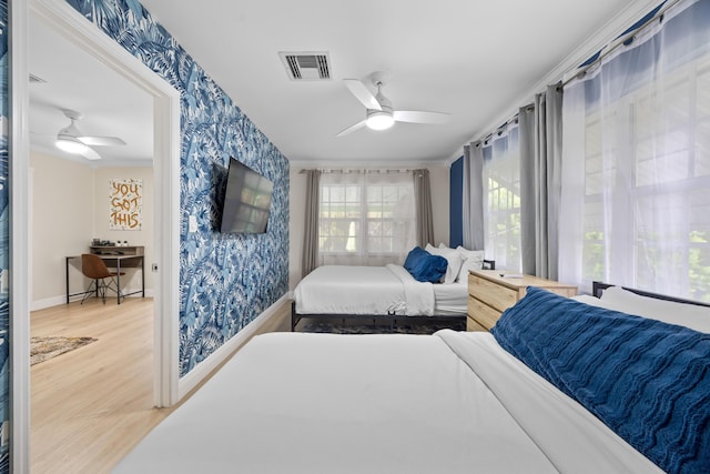 815 Green St, West Palm Beach, FL 33405 - bedroom with wallpapered walls, wood finished floors, and a ceiling fan