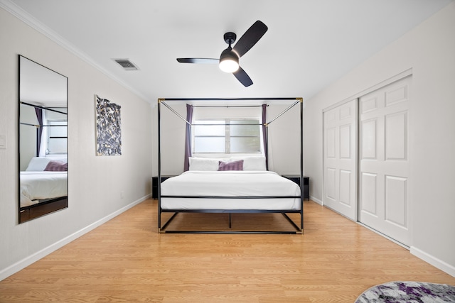 815 Green St, West Palm Beach, FL 33405 - bedroom featuring ornamental molding, a closet, light wood-style floors, and a ceiling fan
