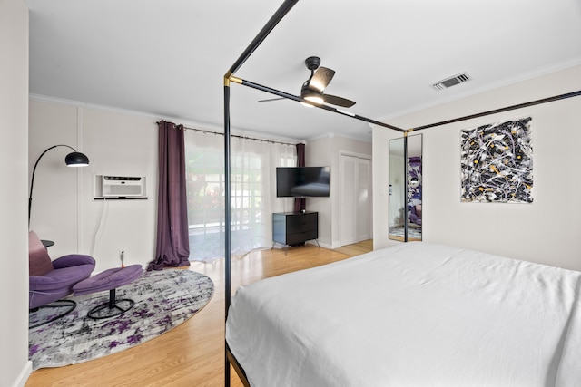 815 Green St, West Palm Beach, FL 33405 - bedroom featuring ornamental molding, wood finished floors, a ceiling fan, and a wall mounted air conditioner