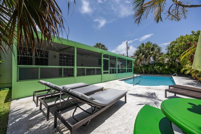 815 Green St, West Palm Beach, FL 33405 - swimming pool featuring a sunroom and a patio area