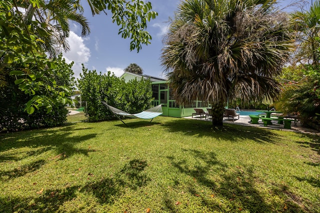 815 Green St, West Palm Beach, FL 33405 - view of yard featuring an outdoor pool, a patio, and a sunroom
