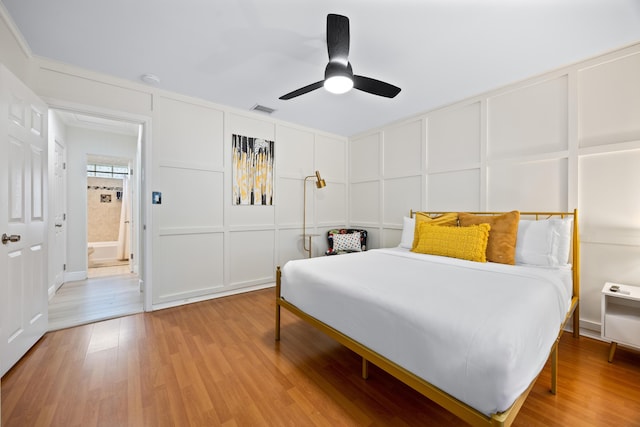 815 Green St, West Palm Beach, FL 33405 - bedroom featuring a decorative wall, light wood-type flooring, and ceiling fan