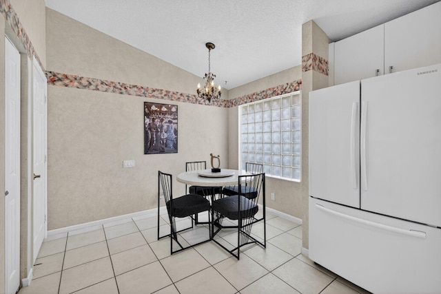 6679 Sherbrook Dr, Boynton Beach, FL 33437 - dining room featuring vaulted ceiling, a chandelier, light tile patterned flooring, and a textured ceiling
