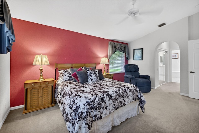 6679 Sherbrook Dr, Boynton Beach, FL 33437 - carpeted bedroom featuring lofted ceiling, arched walkways, ceiling fan, and connected bathroom