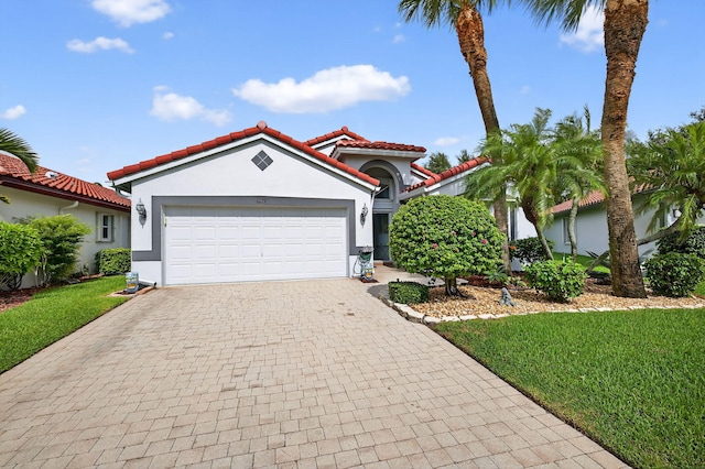 6679 Sherbrook Dr, Boynton Beach, FL 33437 - mediterranean / spanish-style house featuring decorative driveway, stucco siding, a tiled roof, an attached garage, and a front yard
