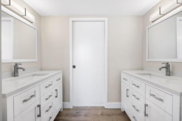 5480 N Ocean Dr Unit B1A, Singer Island, FL 33404 - bathroom featuring wood finished floors and two vanities