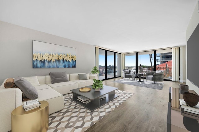 5480 N Ocean Dr Unit B1A, Singer Island, FL 33404 - living room with expansive windows and wood finished floors