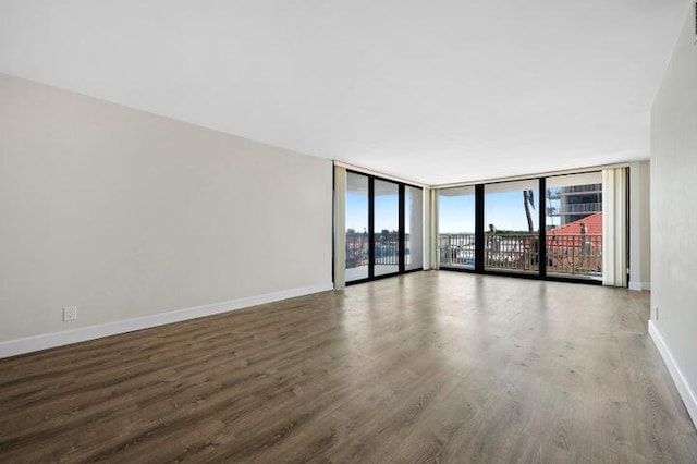 5480 N Ocean Dr Unit B1A, Singer Island, FL 33404 - unfurnished room featuring wood finished floors and floor to ceiling windows
