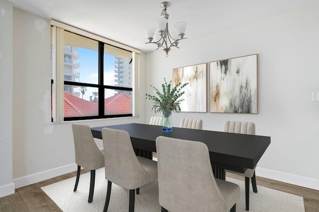 5480 N Ocean Dr Unit B1A, Singer Island, FL 33404 - dining area featuring a chandelier and wood finished floors