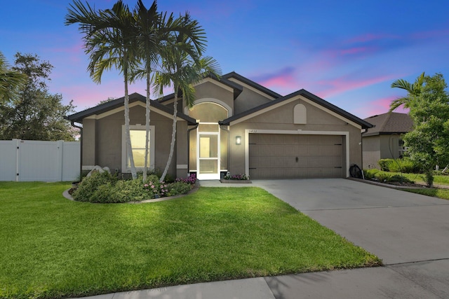 5432 SW Imagination Dr, Fort Pierce, FL 34947 - single story home with an attached garage, stucco siding, driveway, and a gate