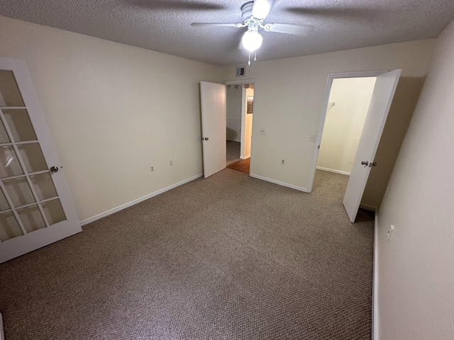 1401 Village Blvd Unit 1914, West Palm Beach, FL 33409 - unfurnished bedroom with carpet, a textured ceiling, and ceiling fan