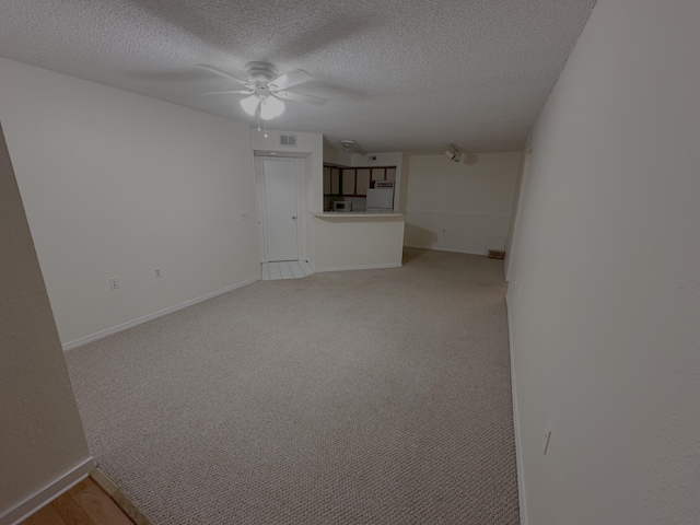 1401 Village Blvd Unit 1914, West Palm Beach, FL 33409 - unfurnished living room featuring a ceiling fan, a textured ceiling, and light carpet