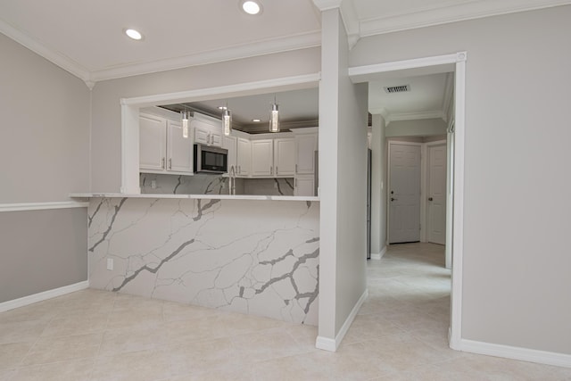 21734 San Simeon Cir, Boca Raton, FL 33433 - kitchen featuring stainless steel microwave, recessed lighting, light tile patterned flooring, white cabinetry, and crown molding