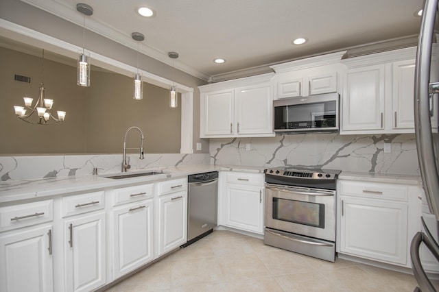 21734 San Simeon Cir, Boca Raton, FL 33433 - kitchen with appliances with stainless steel finishes, crown molding, a chandelier, white cabinets, and backsplash
