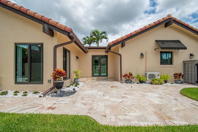 21734 San Simeon Cir, Boca Raton, FL 33433 - rear view of property with french doors, a patio area, stucco siding, and a tiled roof