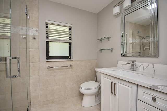 21734 San Simeon Cir, Boca Raton, FL 33433 - full bathroom featuring vanity, tile walls, a shower stall, tile patterned floors, and wainscoting