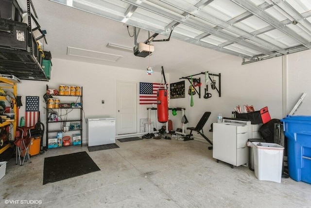 5126 Dandelion St, Apollo Beach, FL 33572 - garage featuring a garage door opener and refrigerator