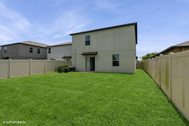 5126 Dandelion St, Apollo Beach, FL 33572 - back of house with a fenced backyard and stucco siding