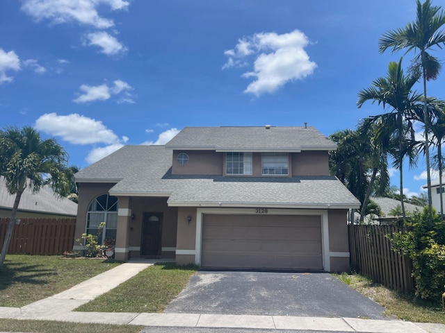 3128 NW 123rd Ave, Sunrise, FL 33323 - traditional-style house featuring stucco siding, asphalt driveway, an attached garage, and roof with shingles