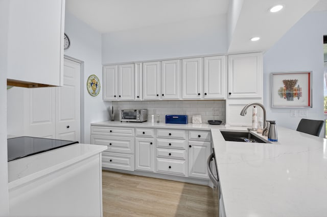19349 Sabal Lake Dr Unit 5046, Boca Raton, FL 33434 - kitchen with tasteful backsplash, white cabinets, recessed lighting, light wood finished floors, and light stone counters