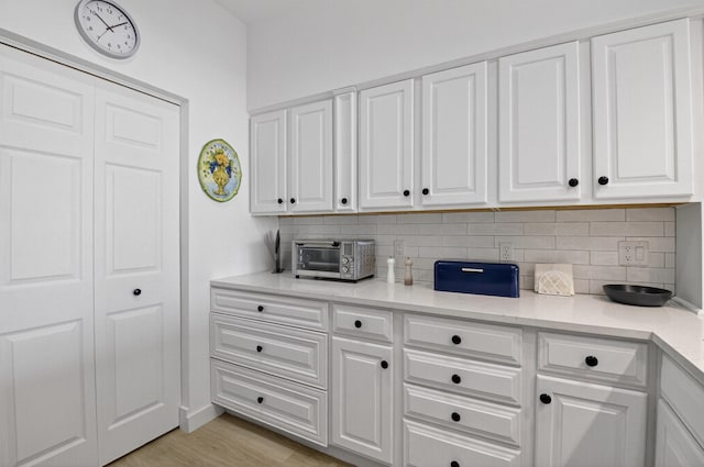 19349 Sabal Lake Dr Unit 5046, Boca Raton, FL 33434 - kitchen featuring backsplash, light countertops, and white cabinets