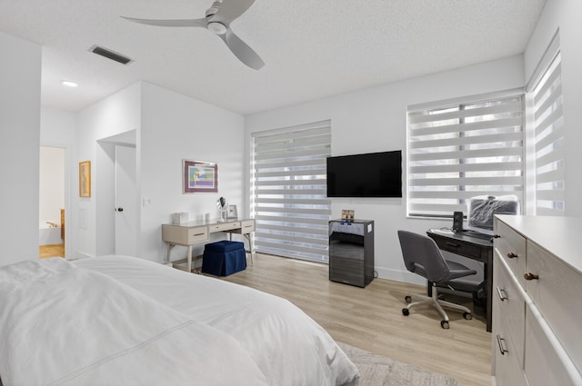 19349 Sabal Lake Dr Unit 5046, Boca Raton, FL 33434 - bedroom with multiple windows, a desk, light wood-type flooring, and a textured ceiling